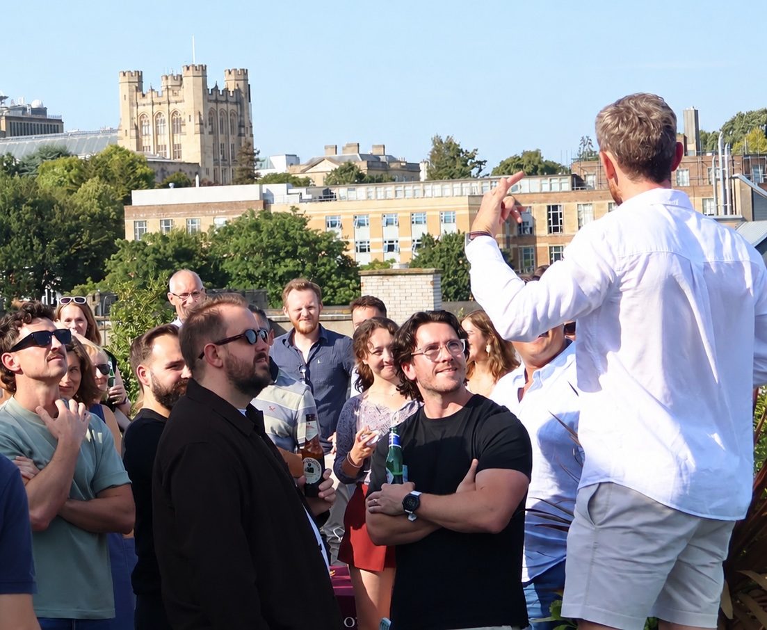 Members of the cohort listening on the rooftop at Origin Workspace, Bristol.
